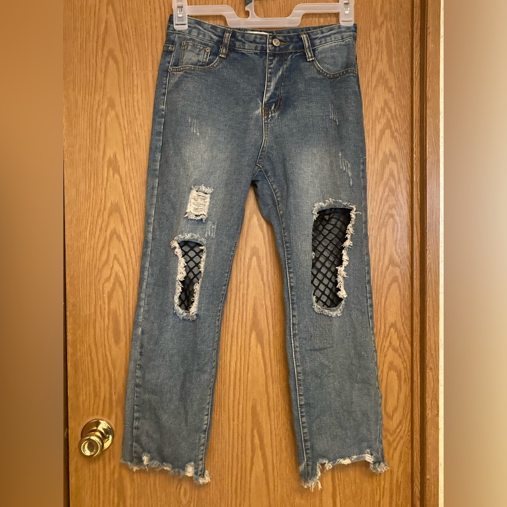 Jeans with built in fishnets and is a medium. Hasn’t been worn but isn’t new.